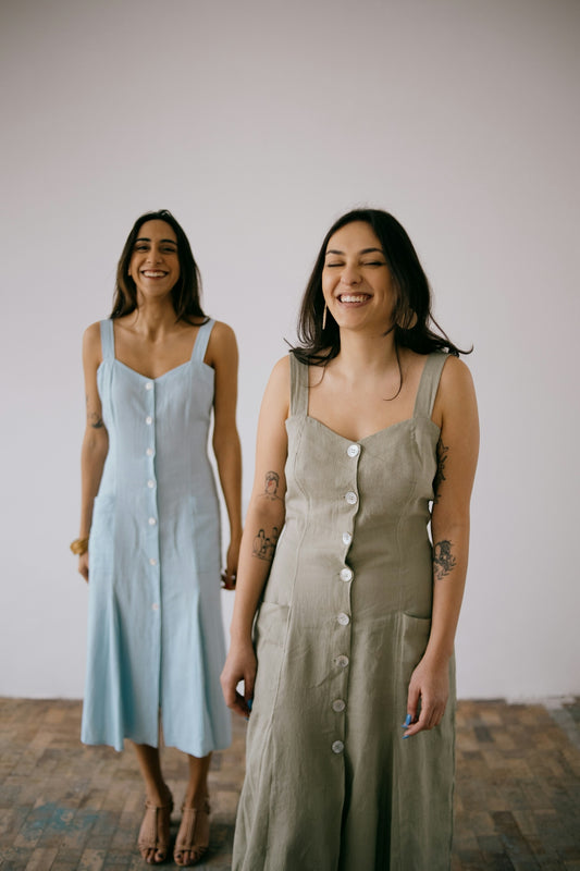 two women standing next to each other on a wooden floor