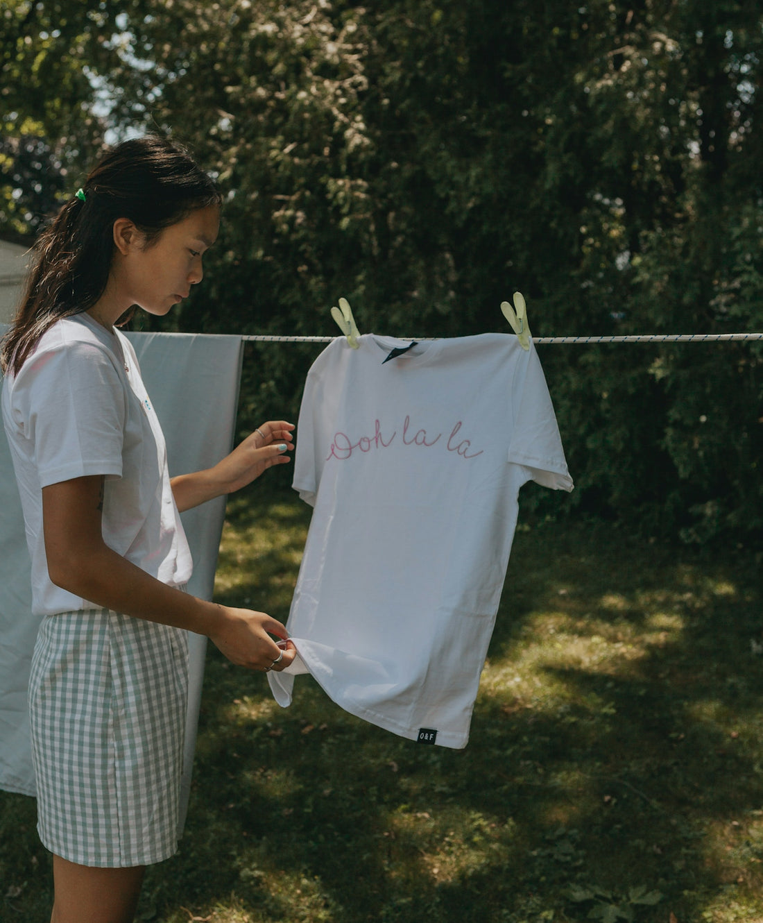 woman in white t-shirt holding white t-shirt