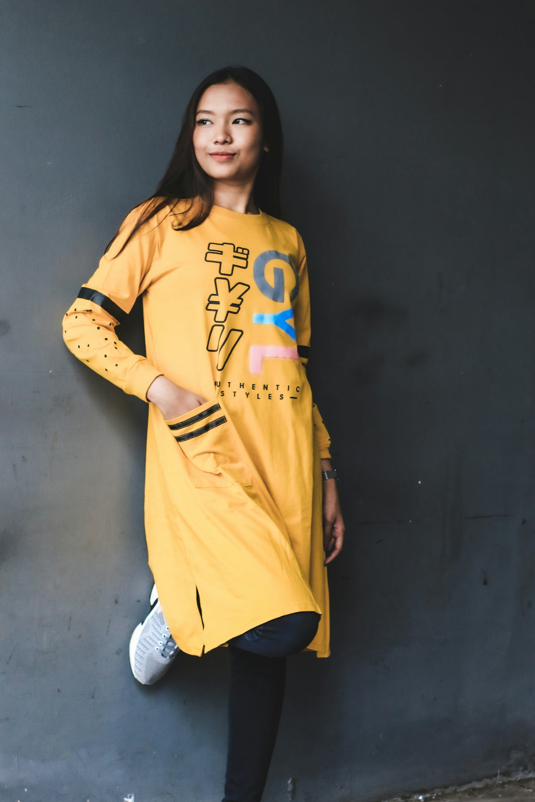 woman in yellow and blue crew neck t-shirt and white denim jeans