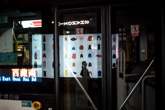 a store front with a display of clothing on the wall
