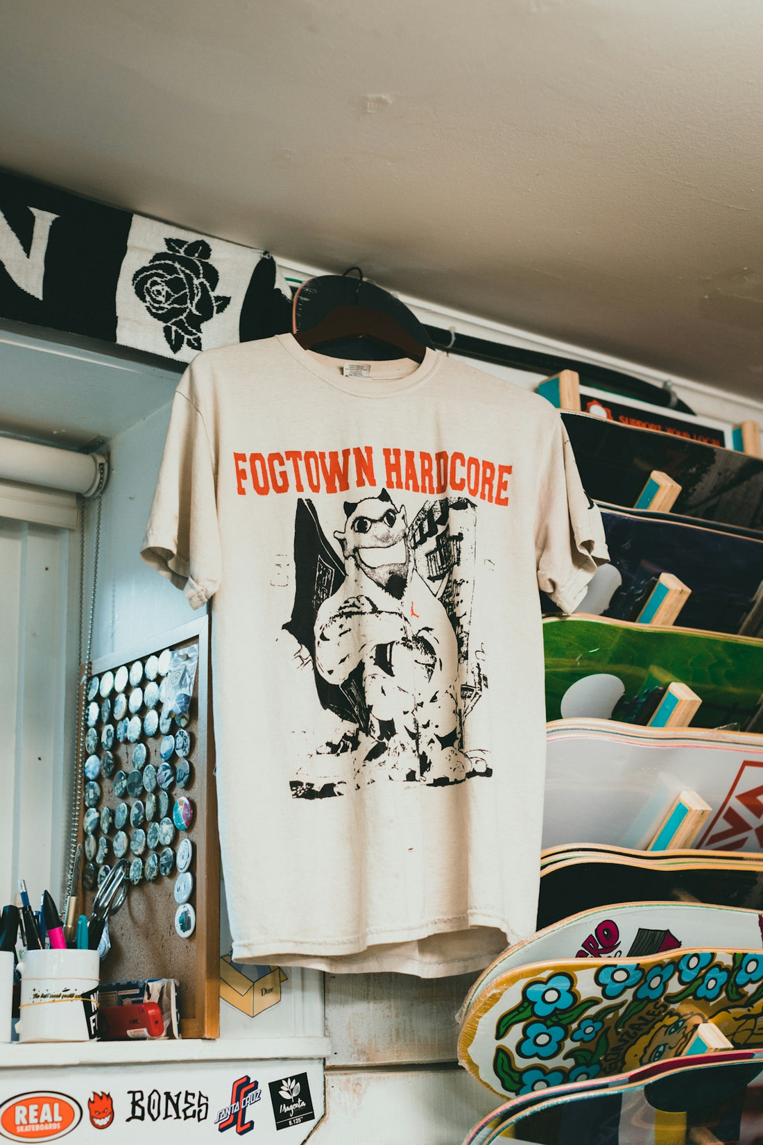 a t - shirt hanging on a rack in a skateboard shop