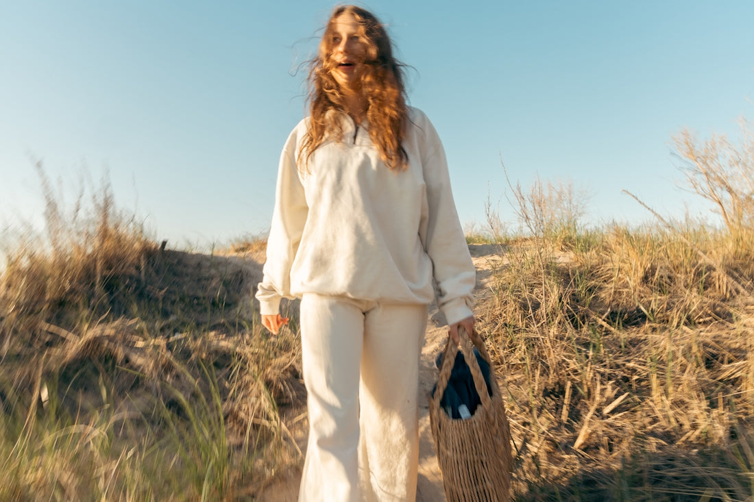 a woman in a white outfit holding a basket