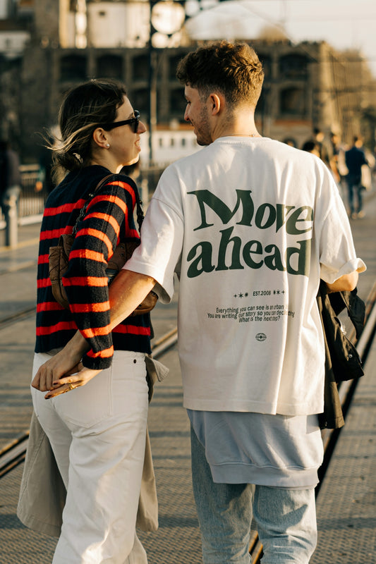 A man and a woman walking down a sidewalk
