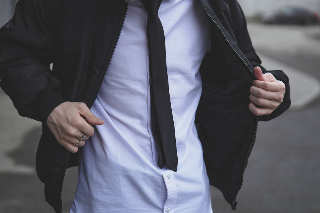 A man is wearing a suit jacket and tie.