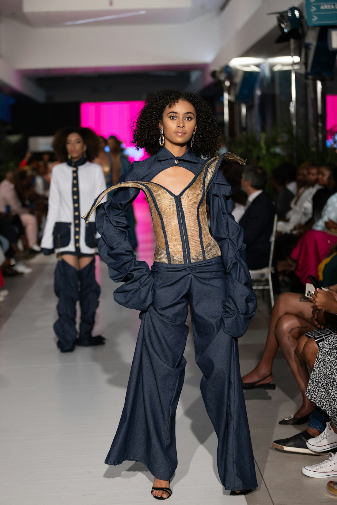 Fashion models showcase avant-garde outfits on the runway.