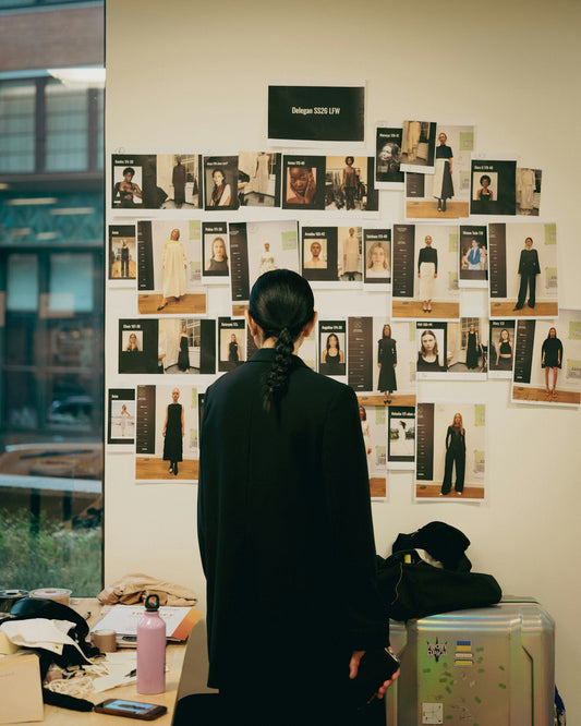 Person looks at mood board with fashion designs