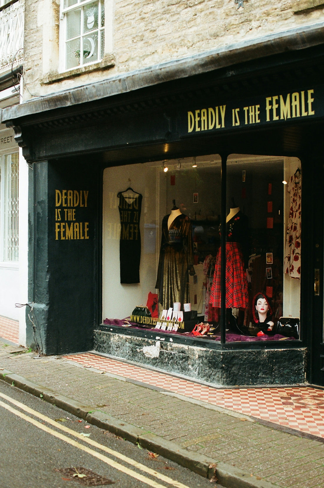 Shopfront with deadly is the female signage and window display.