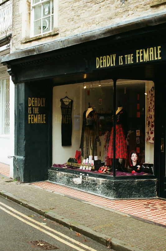 Shopfront with deadly is the female signage and window display.