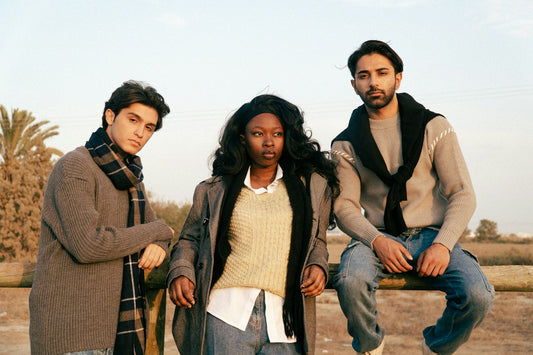 Three diverse young adults posing outdoors together outdoors