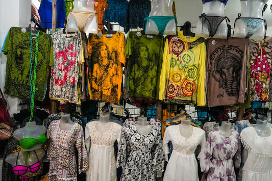 Colorful clothing and swimwear displayed on racks.