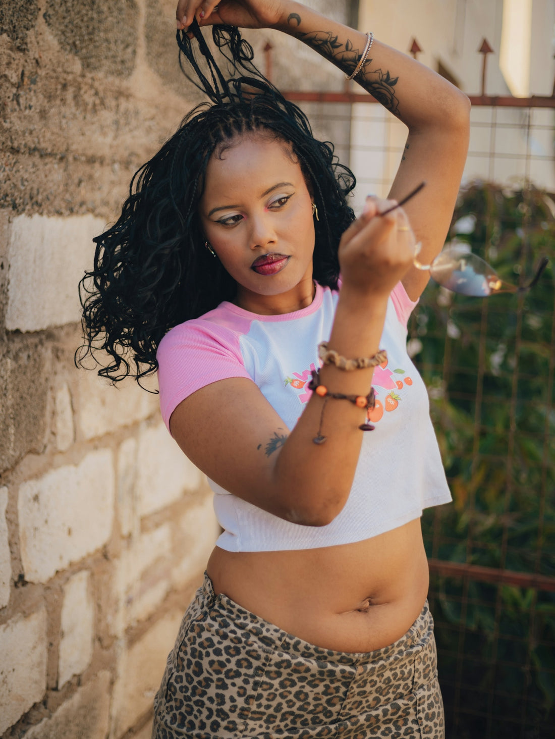 Woman with braided hair adjusts her glasses