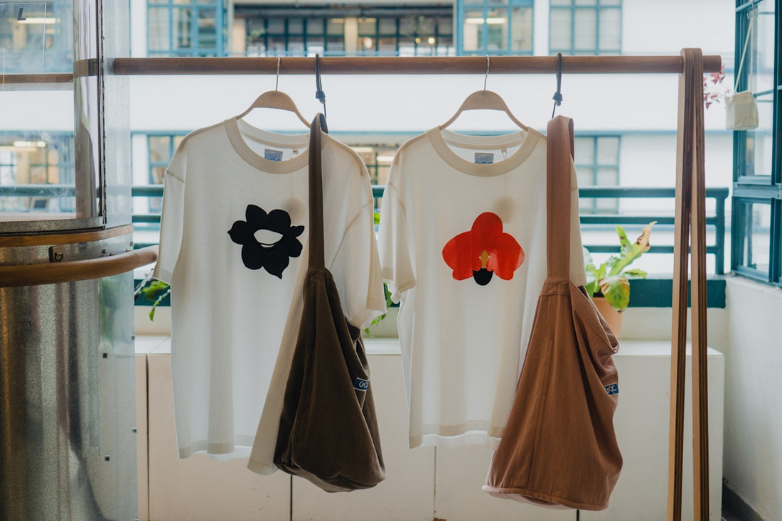 Two white t-shirts with floral appliques and bags