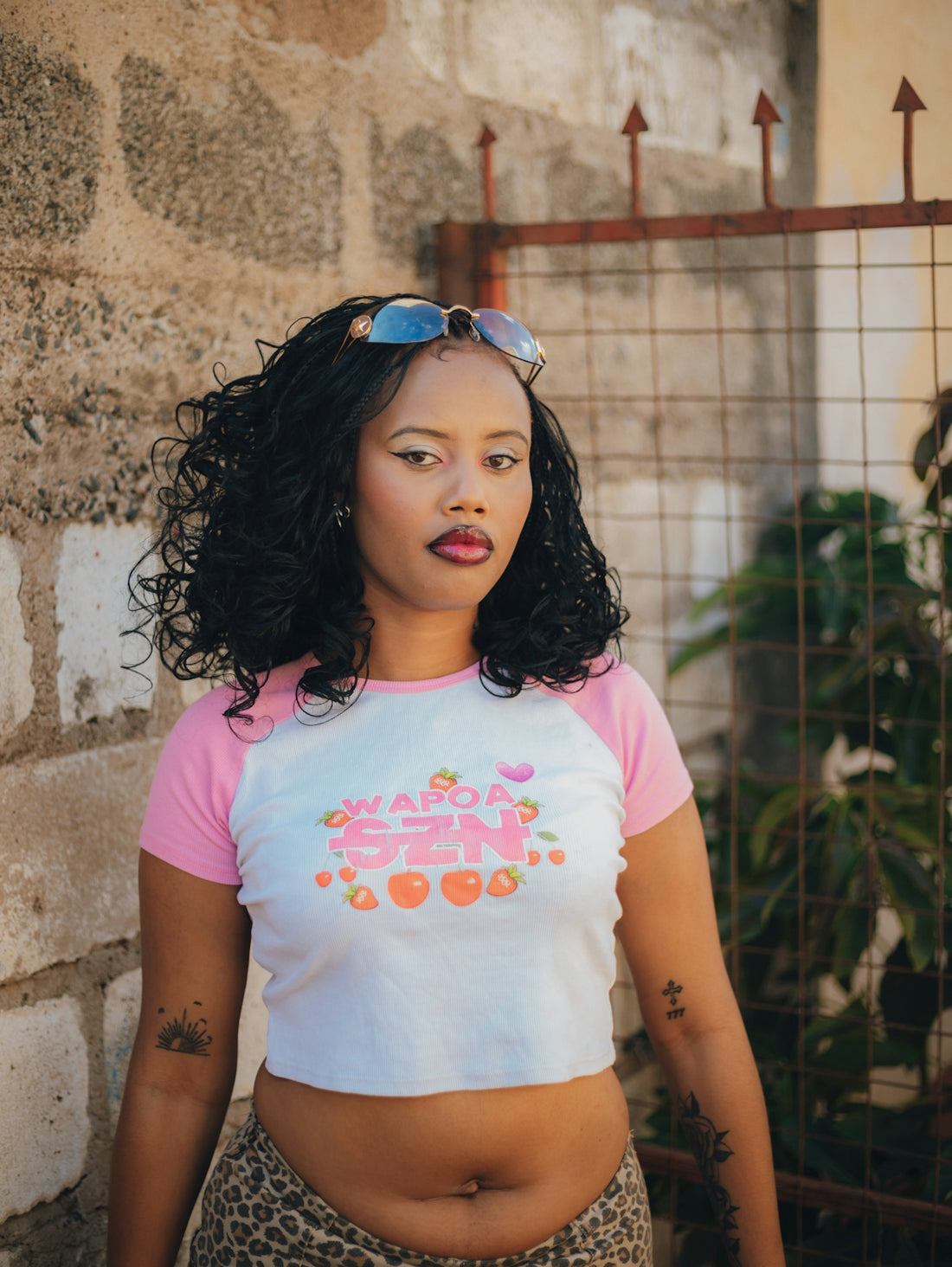 Young woman with sunglasses on head and crop top