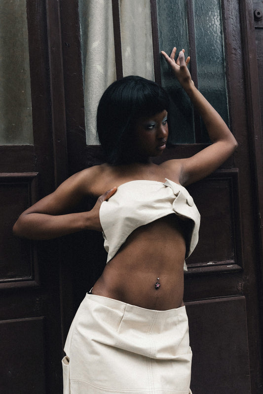 A woman in a white top and skirt